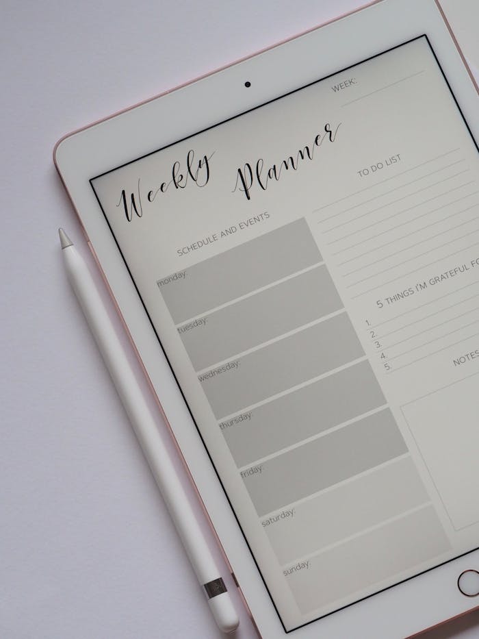 get-in-touch Close-up of a digital weekly planner displayed on a tablet with stylus.